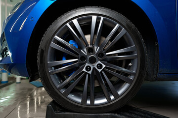 Front wheel of modern blue sport car