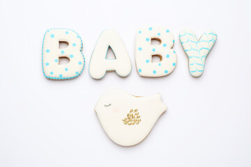Word BABY made of tasty cookies on white background, top view