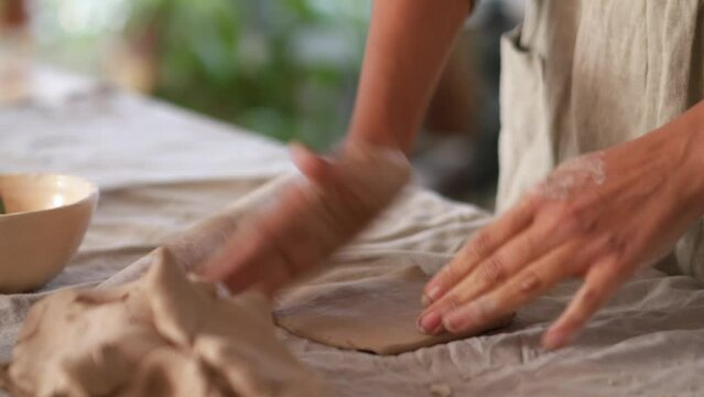 Female hands sculpting something of clay at home