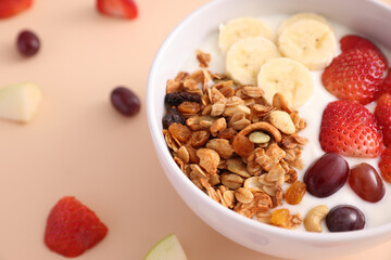 bowl of granola cereal with yogurt and berries isolated on eggnog color background