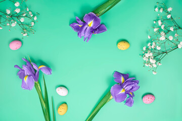 Obraz na płótnie Canvas spring and Easter background with colorful eggs and lilac Iris flower. Top view with copy space