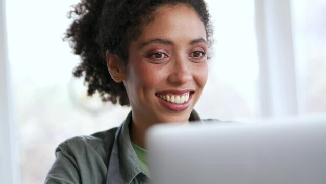 Smiling woman potter texting by laptop at workshop