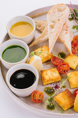 Fried cheese Panir with three sauces: honey, mint, Kabayaki and cashew