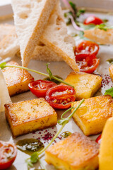 Fried cheese Panir with three sauces: honey, mint, Kabayaki and cashew