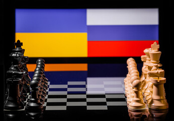 Conceptual image of war between Russia and Ukraine using chess pieces and national flags
