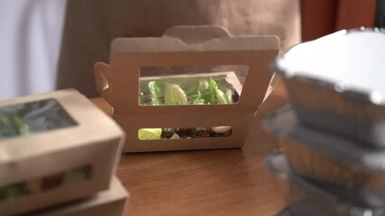 Food delivery services. Restaurant worker collecting a food box take away