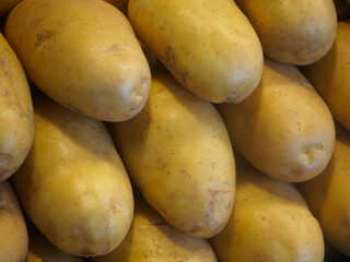 Close-up shot of Neatly stacked large Russet potatoes on a stall