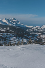 A picturesque vertical landscape view of the French Alps mountains on a cold winter day (Hautes-Alpes, Devoluy valley)