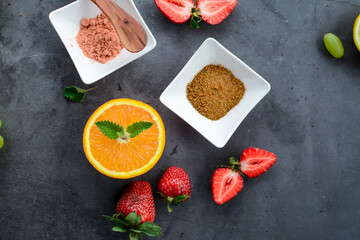 Various fruits and berries on dark gray background