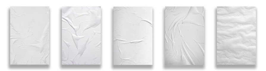 Five sheets of white crumpled paper on a white background.