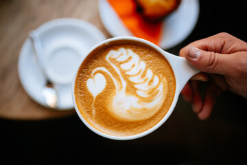 cup of coffee in female hand