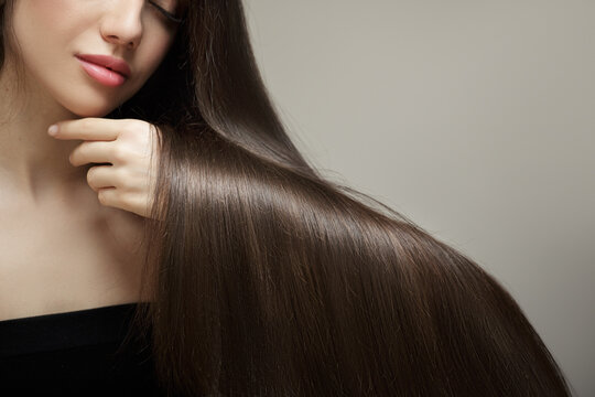 Brunette woman showing straight shiny hair