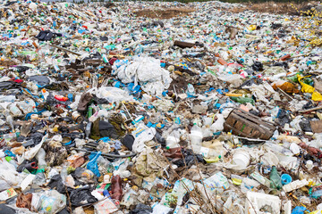Verkhnie-Sergi, Russia - May 02, 2021. dump of household waste under the open sky in nature. a lot...