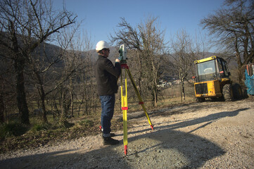 surveyor engineer measuring filds