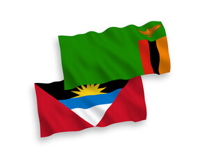 National vector fabric wave flags of Republic of Zambia and Antigua and Barbuda isolated on white background. 1 to 2 proportion.