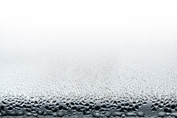 Black dew drops on the glass