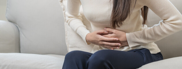 Flatulence asian young woman, girl hand in stomach ache, suffer from food poisoning, abdominal pain...