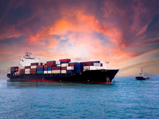 A tugboat towing a container vessel during unberthing at  industrial port.