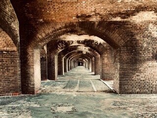 Fort Jefferson, Dry Tortugas National Park, Florida Keys. Brick arches Gunrooms known as casemates, form a honeycomb of brick masonry arches. Linear or geometric perspective to the vanishing point.