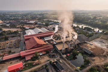 Sugar bioethanol translation factory working with steam from the chimney and sugarcane truck