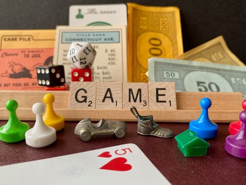 GAME Pieces From Monopoly, Scrabble, Clue, Playing Cards (five Of Hearts), And Dice. Go Directly To Jail Card, Mr. Green, Connecticut Avenue Title Deed, Monopoly House, Letter Tiles, Pawns