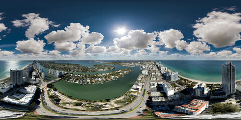 Aerial 360 equirectangular panorama Miami Beach scene with puffy clouds in sky
