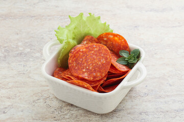 Sliced pepperoni sausage in the bowl