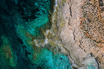 Aerial overview of  blue and green Mediterranean rocky coast of Malta 