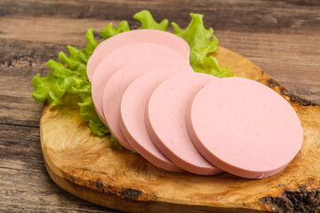 Sliced sausage snak over board