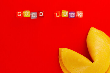 Inscription Good Luck from colorful plastic cubes with chinese fortune cookie on red background with copy space. Ideas concept -You will definitely get lucky. - obrazy, fototapety, plakaty