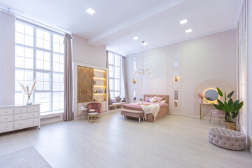 luxurious modern bedroom interior of an expensive spacious light stylish apartment. upholstered furniture and decorative lighting, soft pastel colors and cozy atmosphere