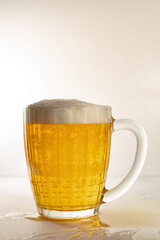 A glass of light, fresh, cold beer. Transparent glass with light beer and thick foam.