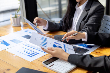 The sales department is having a monthly summary meeting to bring it to the department manager, they are verifying the correctness of the documents that are prepared before bringing in to the manager