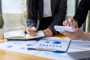 Executives and managers are meeting in a conference room, on the table there are some documents about the company's finances, managers are discussing financial information with the management.