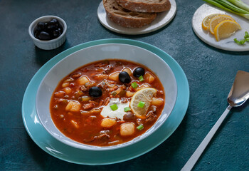 Traditional homemade Russian meat soup Solyanka with black olives and lemon