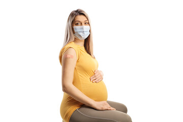 Pregnant woman wearing a mask and a vaccine patch on her arm