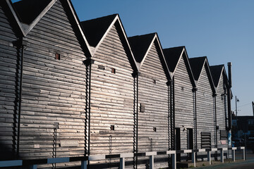 Iconic fishermen huts in black wood in Whitstable harbour, Kent, Uk,