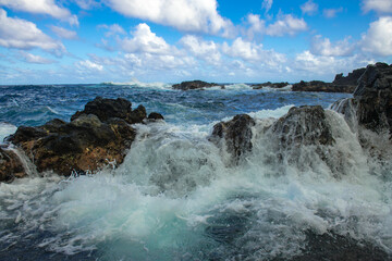 Fototapeta na wymiar Waves hitting the rocks. Rocky cliffs on sea, seascape.