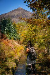 Obraz premium Woman photographing Nossa Senhora da Graca Sanctuary on the top, near a river, in Mondim de Basto, Portugal