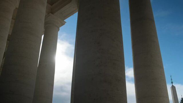 Low angle shot of huge columns of St. Peter square, Vatican, Italy.