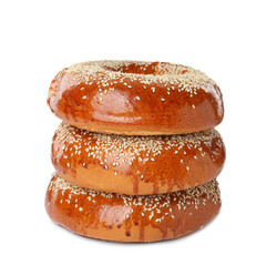 Delicious fresh bagels with sesame seeds on white background