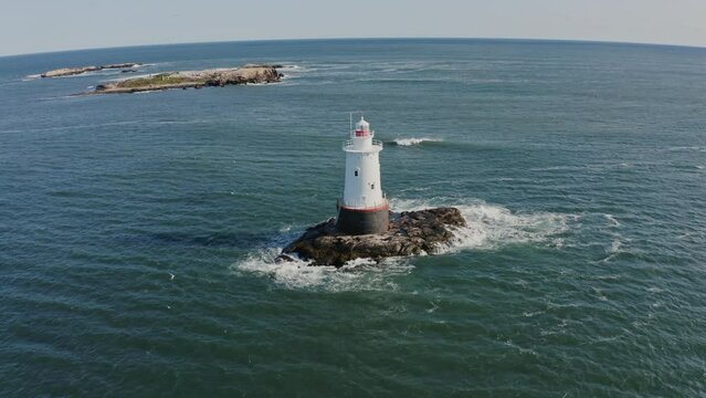White lighthouse on rock island with ocean view