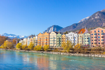 Innsbruck, Austria - 11.21.2021: Historical centre of Innsbruck. Innsbuck landmark. River embankment in Tirol. Winter landscape with Austrian Alps. Sunny day in Alps, Tyrol. 