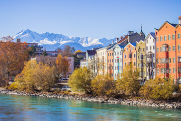 Fototapeta premium Innsbruck, Austria - 11.21.2021: Historical centre of Innsbruck. Innsbuck landmark. River embankment in Tirol. Winter landscape with Austrian Alps. Sunny day in Alps, Tyrol. 