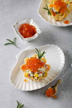 Tartlets with crab sticks, eggs, corn, poppy seeds and caviar.