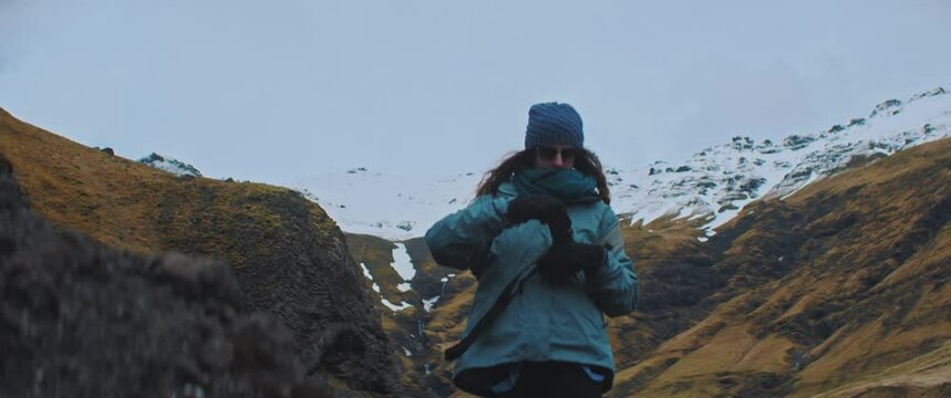Woman takes photo of mountain with camera 