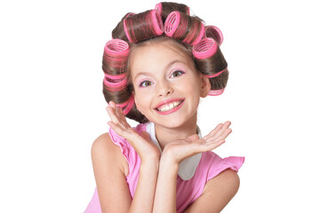 Obraz na płótnie Canvas Portrait of little pretty girl with hair curlers posing