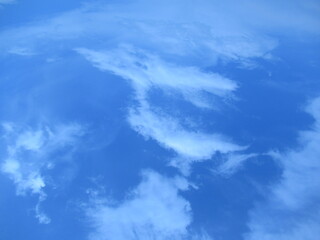 Fototapeta na wymiar blue sky with wierd shaped clouds