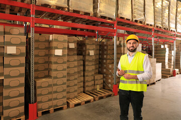 Man with tablet working at warehouse. Logistics center