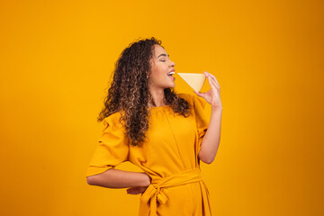 Young afro man with a slice of brie cheese in his hands. Young woman eating cheese